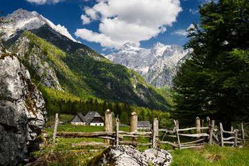 High alpine farmstead in Zadnja Trenta Valley with view of Prisojnik and Razor Peaks in Triglav National Park Julian Alps Slovenia in Spring