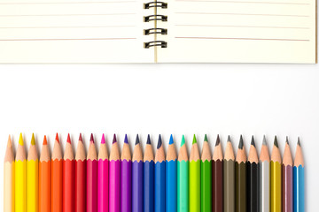 color pencils with notebook on white background.