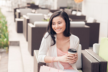 Lovely woman with coffee and shopping bags