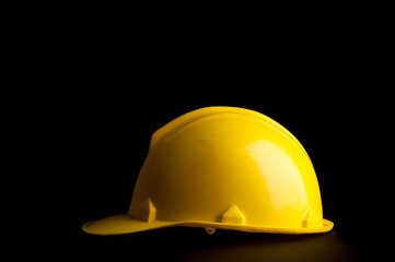 Yellow safety helmet on black background.