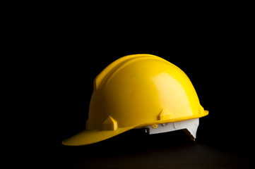 Yellow safety Worker and Engineer helmet on black background.