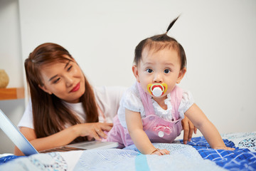 Crawling baby with pacifier