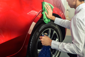 Man asian inspection and cleaning Equipment car wash With red car For cleaning to quality to customer on car showroom of service transport automobile transportation automotive image.