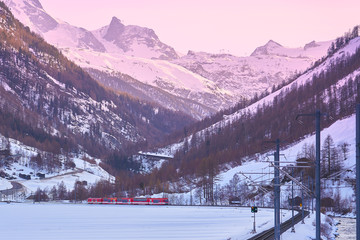Railway transportation from Täsch station to Zermatt with winter alps mountain range in background.