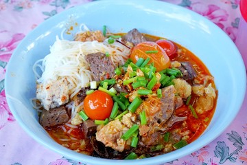 Thai food style, Rice noodles with spicy pork sauce in bowl, This food is the most popular in northern Thailand, Khanom Jin Nam Ngiao is Thai traditional (Kanom Jeen Nam Ngeaw)