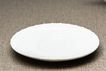 Close up setting of White plate on the wooden table.