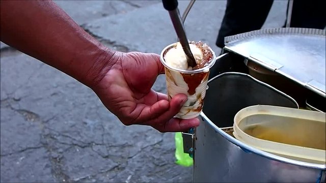 Handheld video shot of Filipino delicacy called Taho or soy bean curd being scoop by a vendor