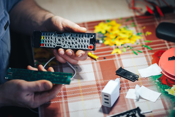 man hands repair make broken tv remote