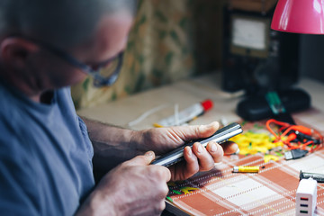 man hands repair make broken tv remote