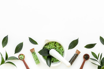 Make cosmetics with tea tree essential oil. Fresh tea tree leaves, mortar and pestel, cosmetics on...