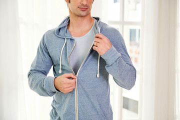 Man zipping up hoodie