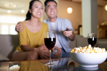 Happy couple watching movie at home