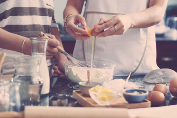 Women making dough for cake