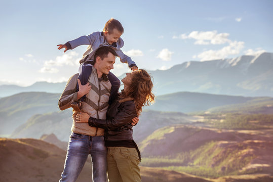 Happy Family With Son In Mountains