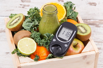 Glucose meter with sugar level and freshly blended coctail from fruits and vegetables. Diabetes and...