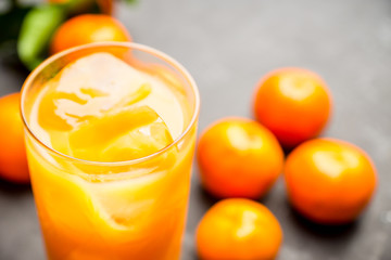 Fresh beverage with mandarines on the rustic background. Selective focus. Shallow depth of field.
