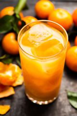 Fresh beverage with mandarines on the rustic background. Selective focus. Shallow depth of field.