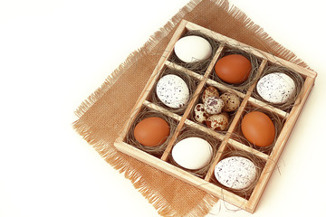 Easter. Easter eggs lie in a box, on a light background. Selective focus, toning, blur.