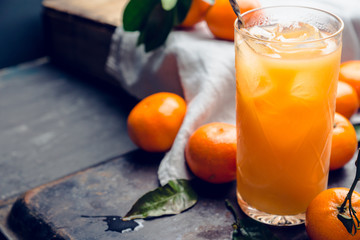 Fresh beverage with mandarines on the rustic background. Selective focus. Shallow depth of field.