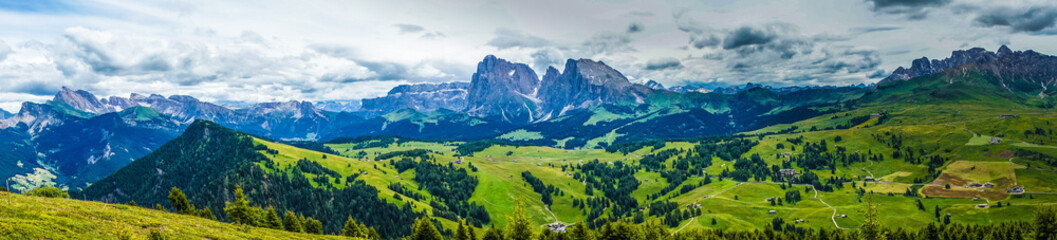 Naklejka na ściany i meble Alpe di Siusi, Seiser Alm with Sassolungo Langkofel Dolomite, lush green field in Seiser Alm Puflatsch Bullaccia