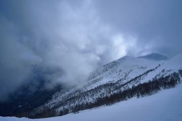 Image of a mountain covered with a snow cloud.