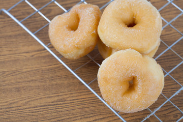 Donut on grille isolated on wood table.