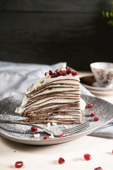 A slice of chocolate crepe cake