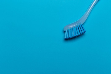 dish washing brush on blue background