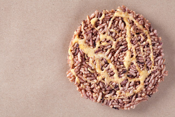 Nang Let is a name of rice cake round and flat sweetmeat is a dessert in Thailand, Put on brown paper background.