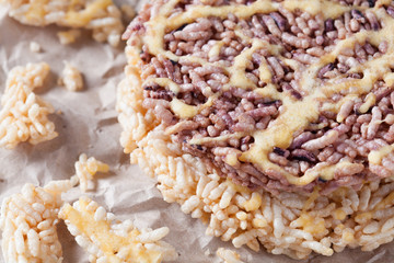 Nang Let is a name of rice cake round and flat sweetmeat is a dessert in Thailand, Put on crumpled brown paper background.