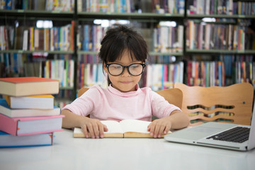 Little girl reading the book