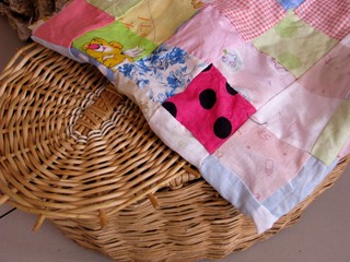 Basket, covered with a blanket in patchwork