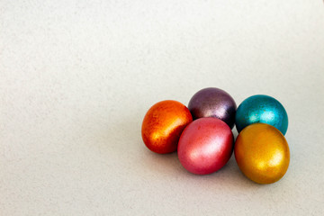 bright colored Easter eggs (pink, blue, orange, yellow, purple); marble pattern, neon colors, shiny paint, copy space