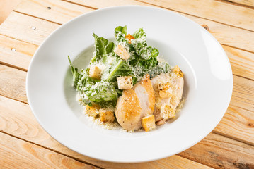 fresh caesar salad in the white plate