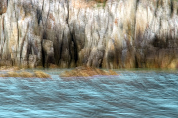 Obraz na płótnie Canvas Abstract blurred image of sea and cliffs. Intentional camera movement technique.