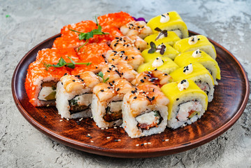 Rainbow Sushi Roll with salmon, eel, tuna, avocado, royal prawn, cream cheese Philadelphia, caviar tobica, chuka. Sushi menu. Japanese food