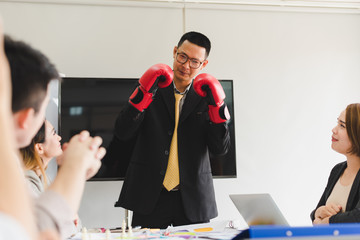 A group of Asian businessmen are discussing their work. Boxing business concept by presendent.