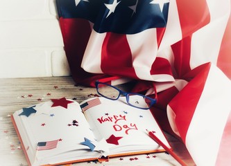 Fototapeta premium Diary with glasses open on the date of July 4, happy independence day, patriotism and memory of veterans 