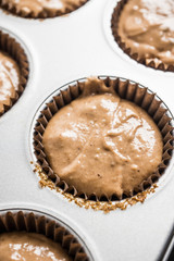 Muffins making. Raw chocolate dough in form ready to bake. Selective focus. 