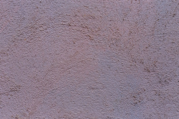 a fragment of a wall of roughly plastered concrete as a background