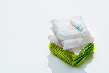 Clean white cotton tampon and pads on a white background.  Woman hygiene protection in period. Menstruation cycle, critical days concept.