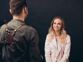 smiling good looking girl with long fair hair listening to the photographer's reccomendations, interesting conversation with a professional photographer