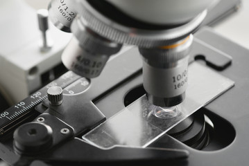 Blurred microscope lens close up photo. Examination of samples under the microscope abstract background.
