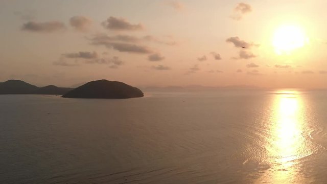 Sunset over tropical island beach,  Samui,  Thailand. Bird flying to the sea. 2.7K