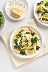 Spaghetti with spinach leaves, grilled chicken breast and cheese