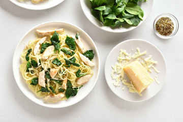 Spaghetti with spinach leaves, grilled chicken breast and cheese