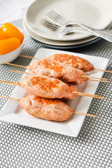 Minced turkey kebabs on square white plate