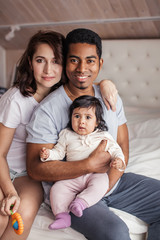 Fototapeta premium happy diverse family looking at the camera indoors, close up photo
