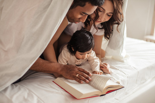 positive young couple enjoying reading a book at night, close up photo, education, studing