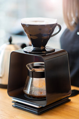coffee maker makes coffee in a cafe